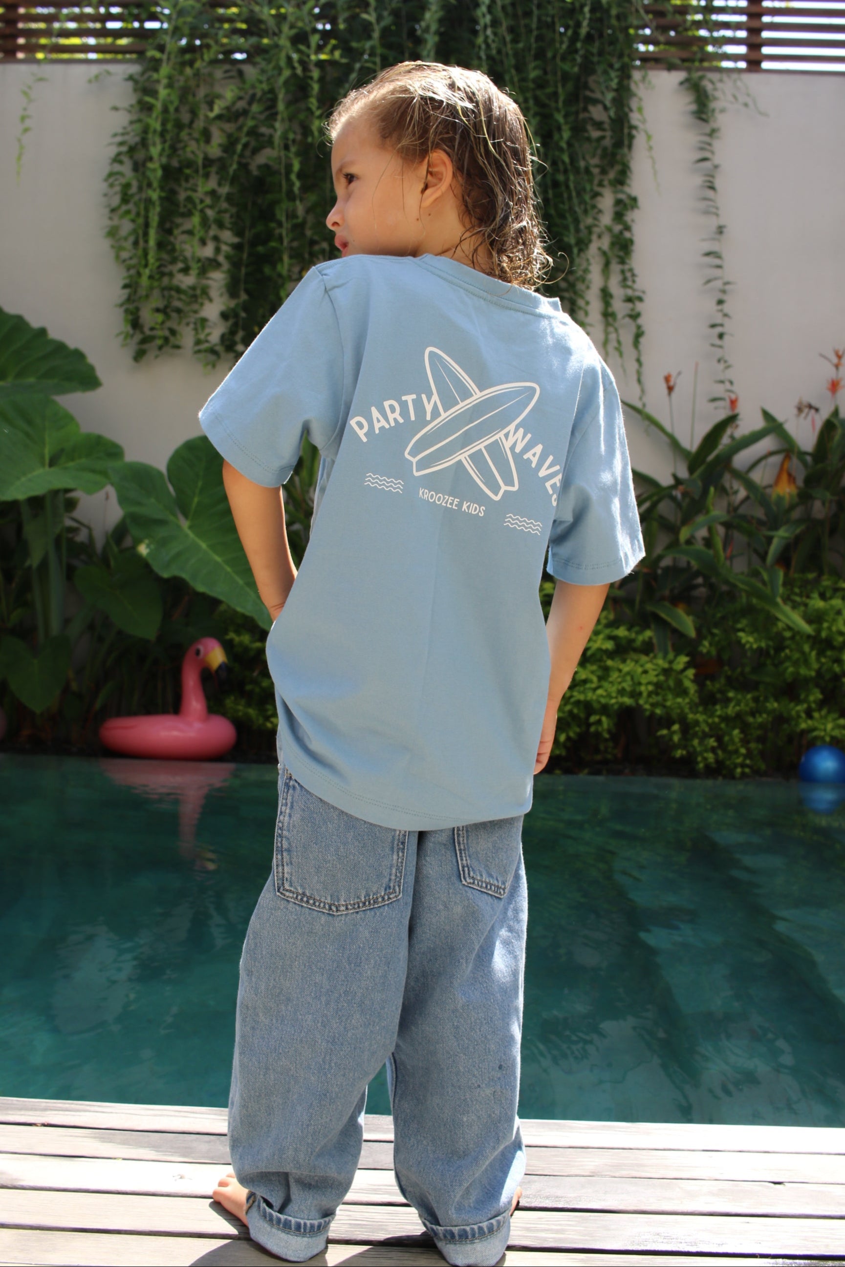 Person wearing a light blue hoodie with text and graphics, standing outdoors.